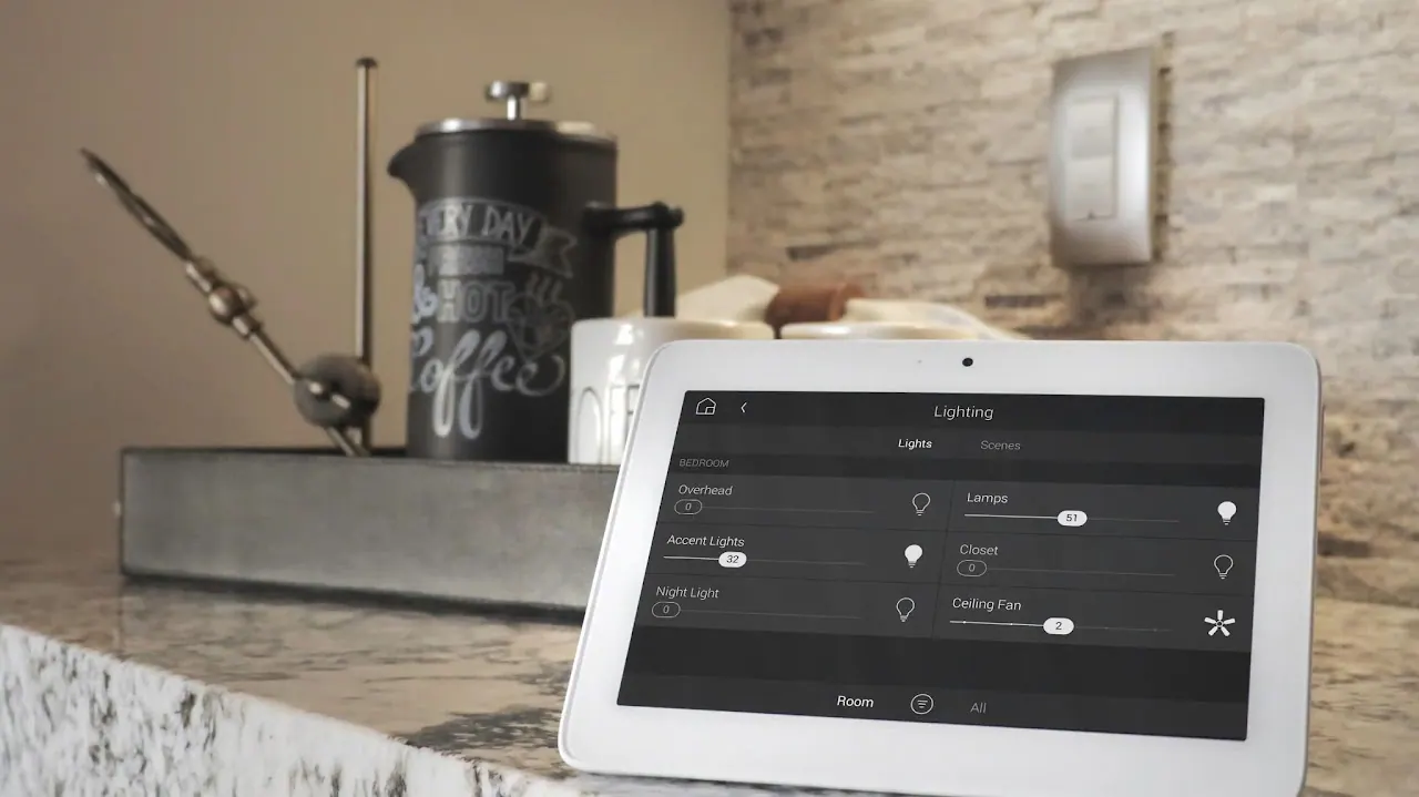 Touchscreen displaying home lighting controls on a countertop
