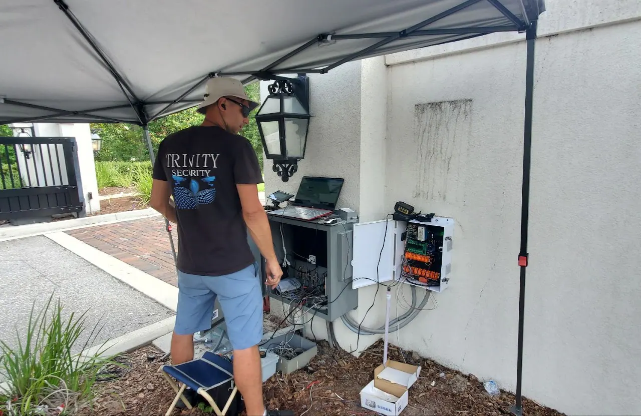 Technician with a laptop at a gate-side equipment cabinet