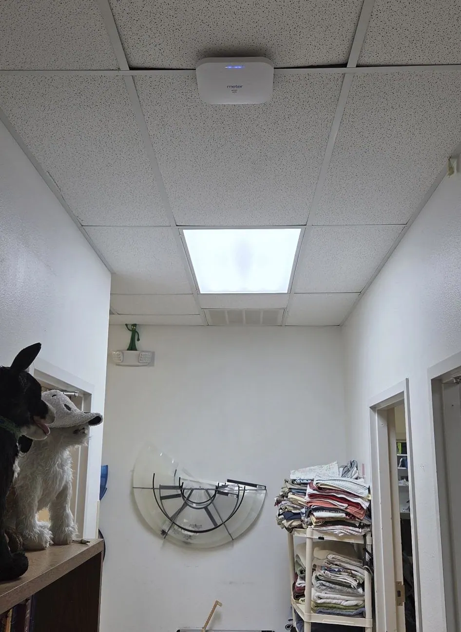 Small office room with a ceiling light and wall-mounted shelving