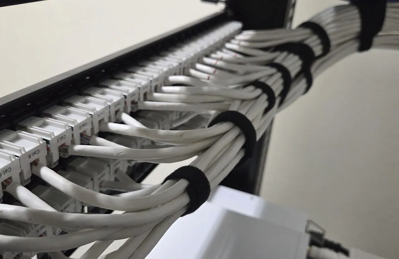 Cat 6 patch panel with cables bundled by hook-and-loop straps.