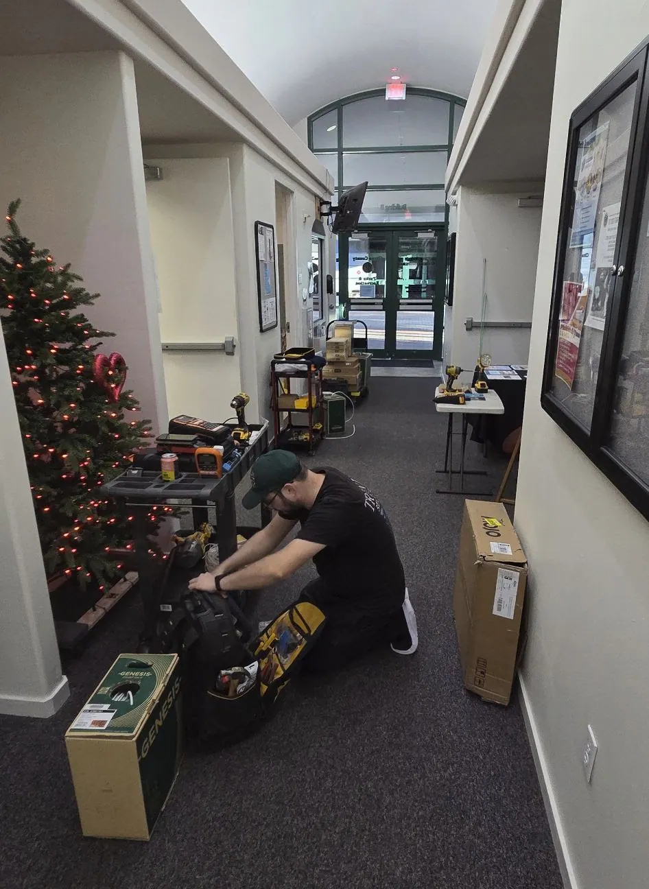 Corridor with a holiday tree and a technician working on the floor