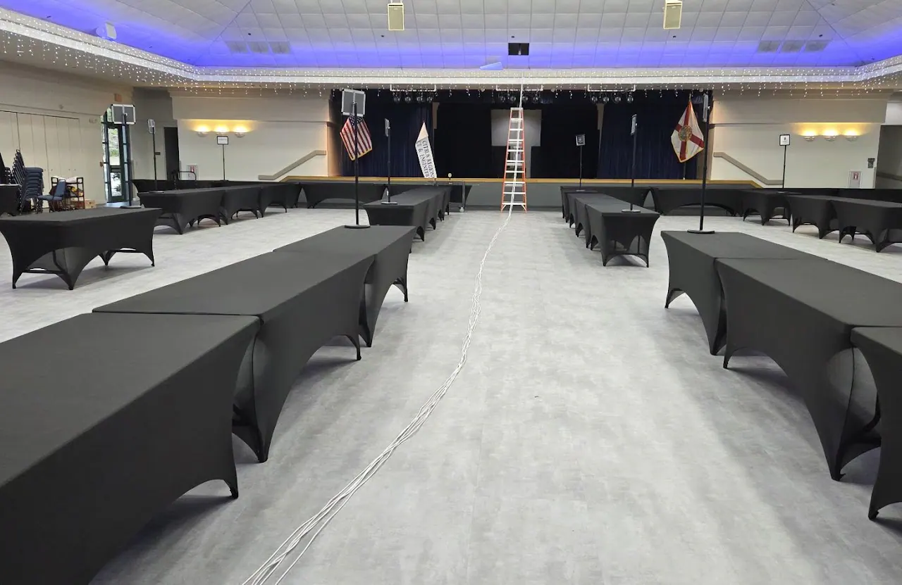 Hall with blue ceiling lighting and a stage