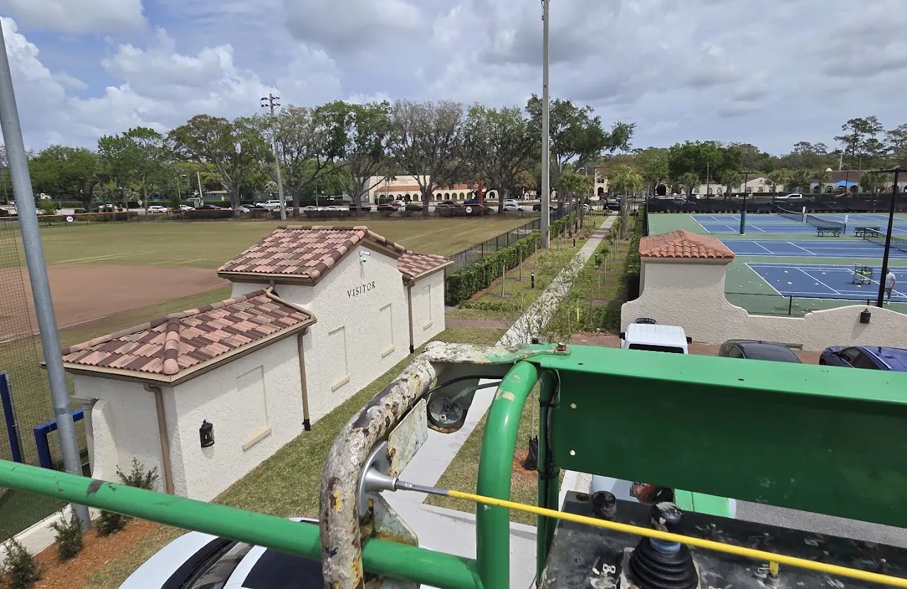 Elevated view over tennis courts and terracotta roofs from a lift