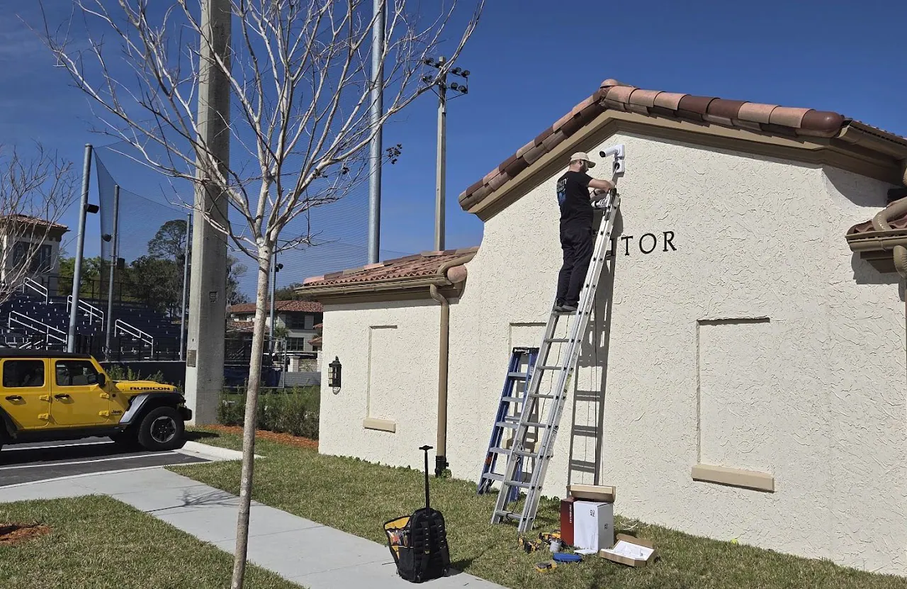 Two ladders against a stucco building marked VISITOR