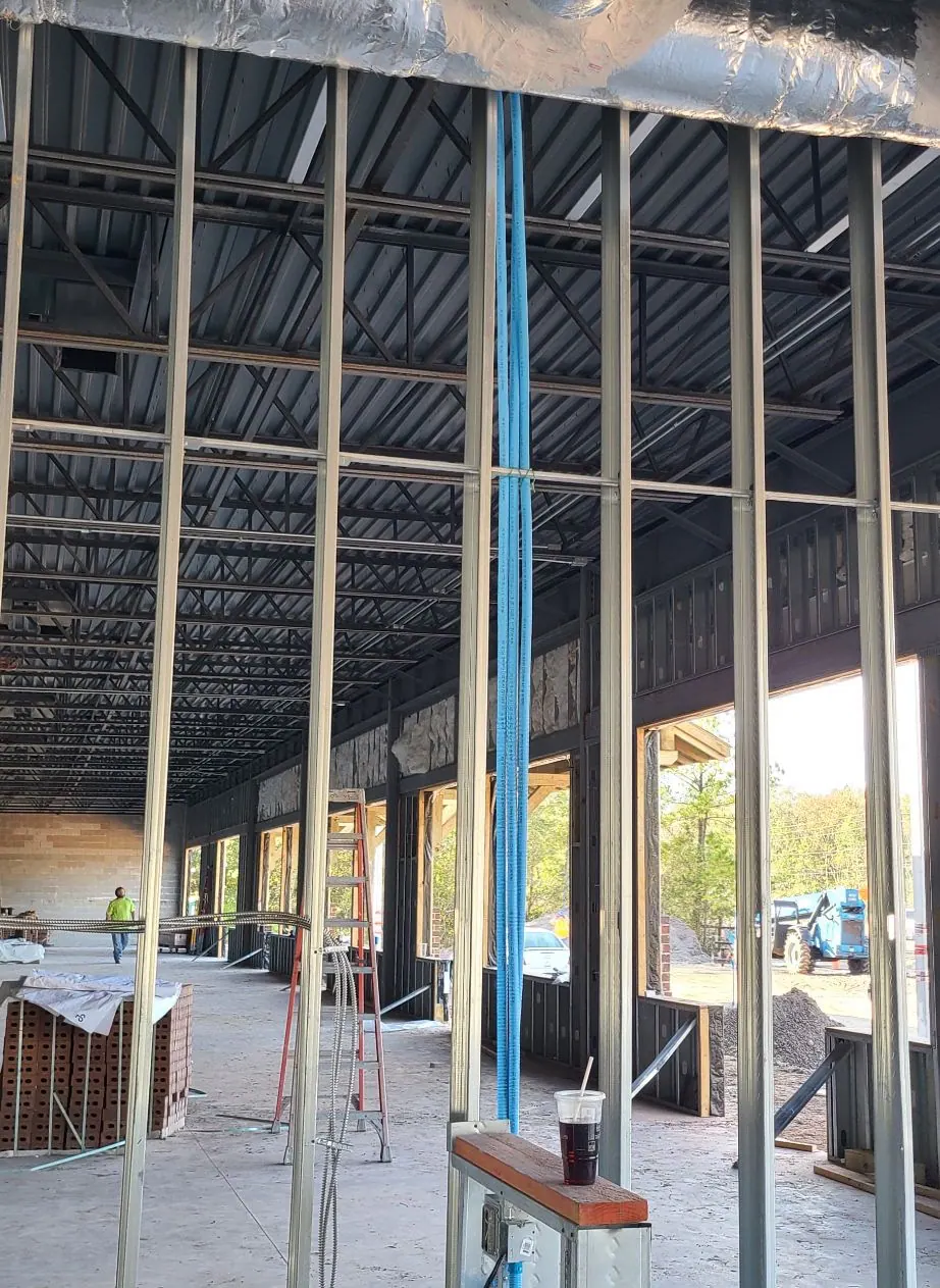 Open steel frame and roof structure of a building under construction