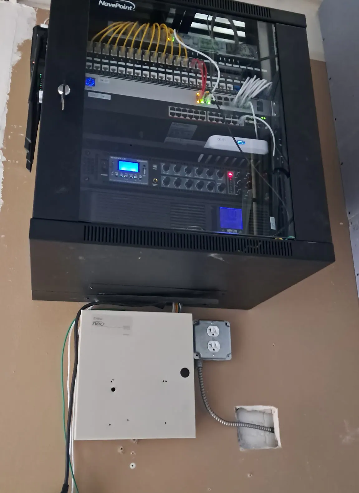 Open wall cabinet with an equipment rack and a power box below