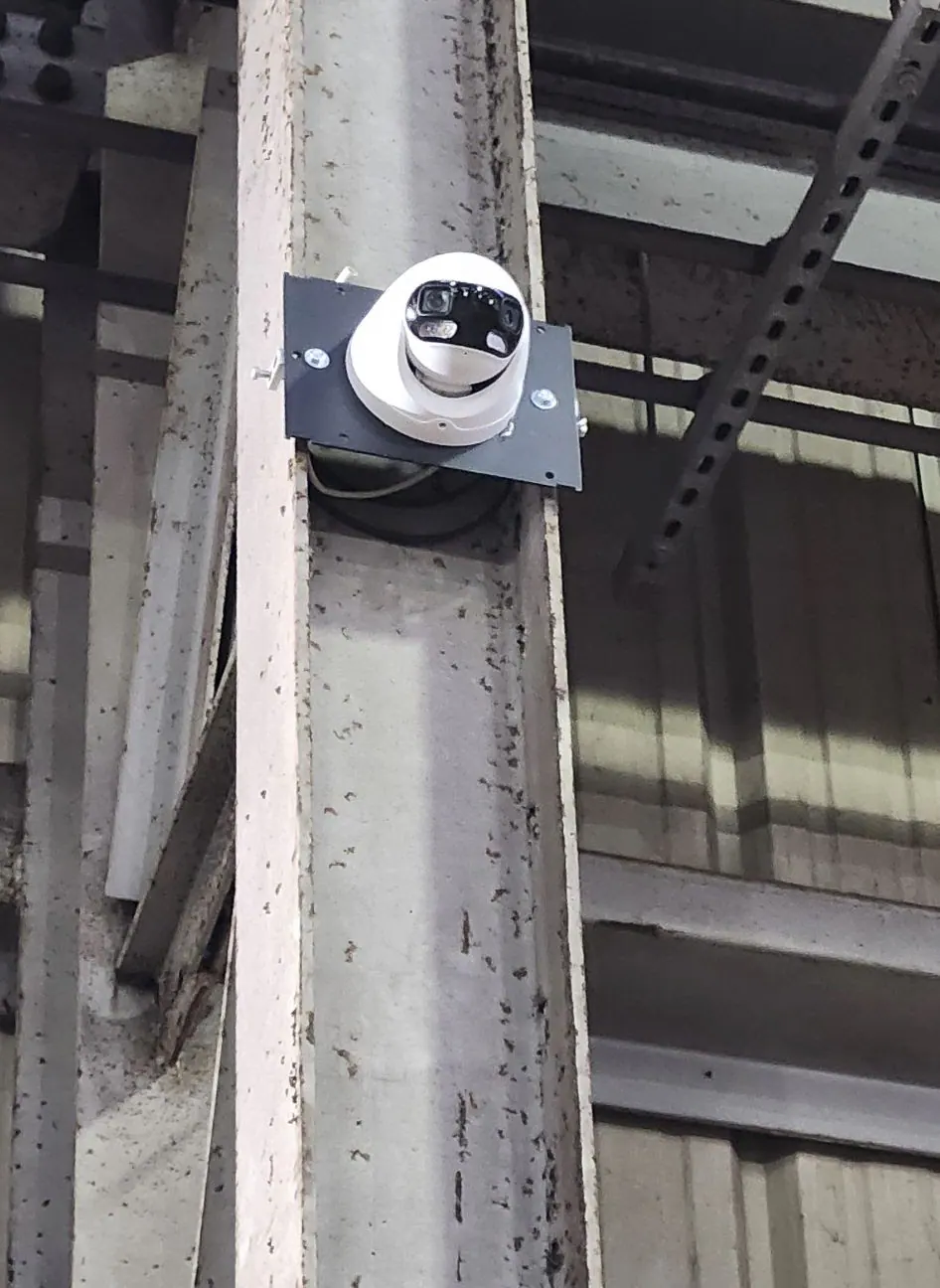 Dome camera mounted on a steel column in a large building